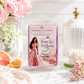 Chandelier & Savon 'Long Live the Queen' scented wax melt in a clear plastic clamshell package, styled on a white marble surface with pink roses, white flowers, a grapefruit slice, and a glass bottle in the background.