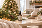 A small amber dropper bottle labeled 'AROUND THE TREE' sits on a marble coffee table in a cozy living room decorated for Christmas, with a lit tree, knit blanket, and diffuser in the background.