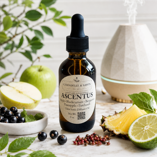 A bottle of Chandelille & Savion Ascendant Style: Blackcurrant + Bergamot Pineapple + Patchouli ultra sonic diffuser oil, styled with fresh fruits, berries, mint, and a diffuser in the background.