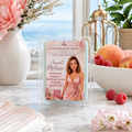 A packaged wax melt or scented candle sits on a marble surface in a styled indoor scene with flowers, peaches, raspberries, and a window view in the background. The front label reads CHANDELE  & SAVON and Sweet Melissa, with a woman pictured on the packaging.
