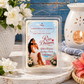 A packaged wax melt or scented melt product labeled 'Chandelle & Savon Rio Dreams' sits on a rustic wooden surface with decorative flowers, a white ceramic candle holder with a lit candle, and a blue wall in the background. The product is enclosed in a clear plastic clamshell with a printed front label showing an illustrated woman and floral artwork.