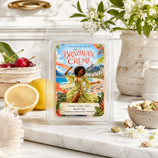 A wax melt package labeled 'Brazilian Creme' by Chandelle & Savon, displayed on a marble surface with lemons, cherries, nuts, and flowers around it.