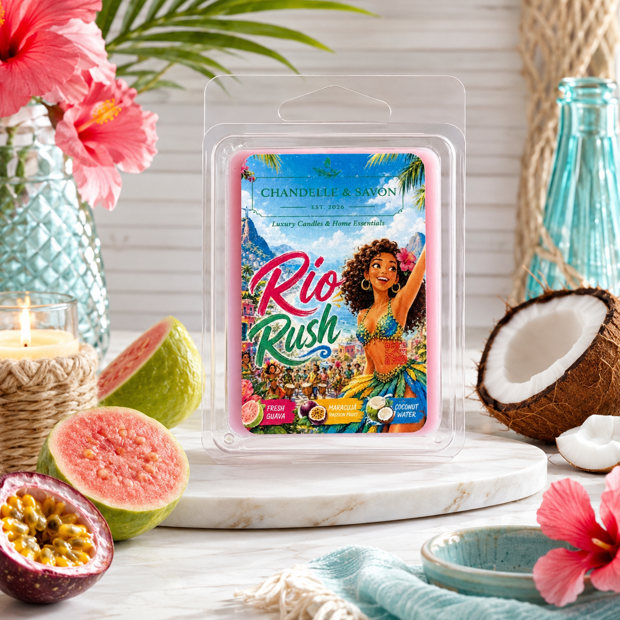 Chandelle & Savon Rio Rush tropical wax melts in a clear clamshell package, styled on a marble coaster with guava, a coconut, pink hibiscus flowers, and a blue glass bottle.